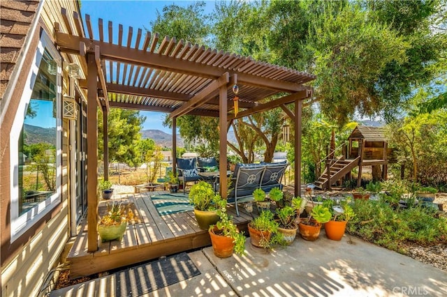 view of patio / terrace featuring a pergola and a deck with mountain view