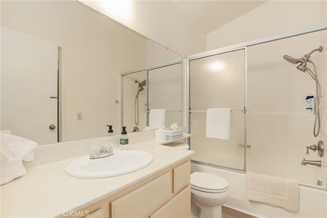 full bathroom featuring enclosed tub / shower combo, vaulted ceiling, toilet, and vanity