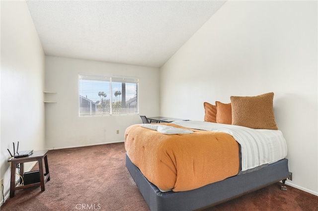 carpeted bedroom with a textured ceiling and lofted ceiling