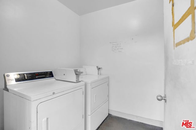 clothes washing area featuring washing machine and clothes dryer