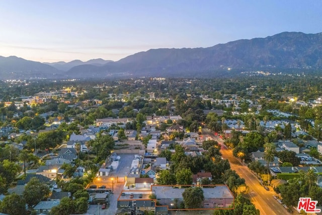 aerial view at dusk featuring a mountain view