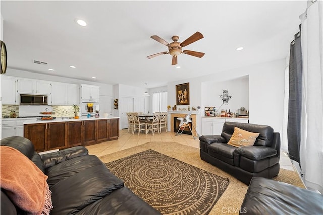 living room featuring recessed lighting, visible vents, ceiling fan, and light tile patterned floors