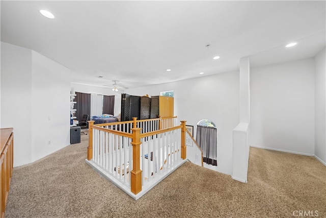 corridor with carpet, recessed lighting, and an upstairs landing