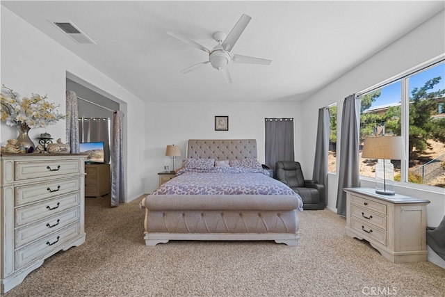 bedroom featuring light carpet, visible vents, and a ceiling fan