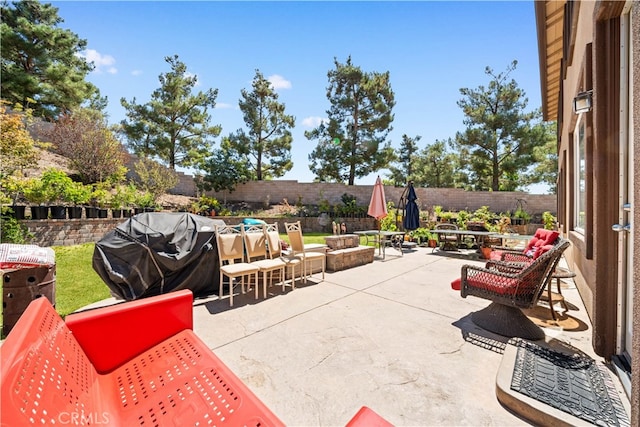 view of patio / terrace with an outdoor fire pit, a fenced backyard, and area for grilling