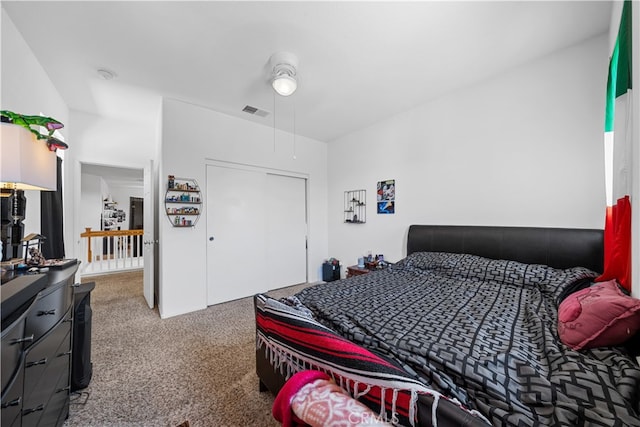 carpeted bedroom featuring a closet and visible vents