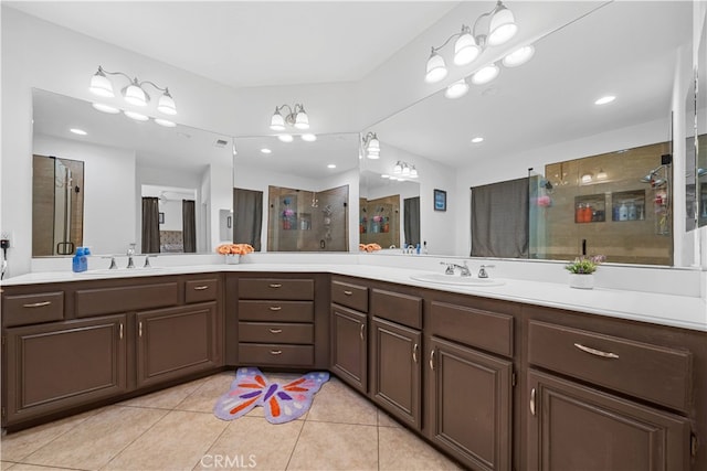 bathroom featuring a stall shower, tile patterned flooring, and vanity