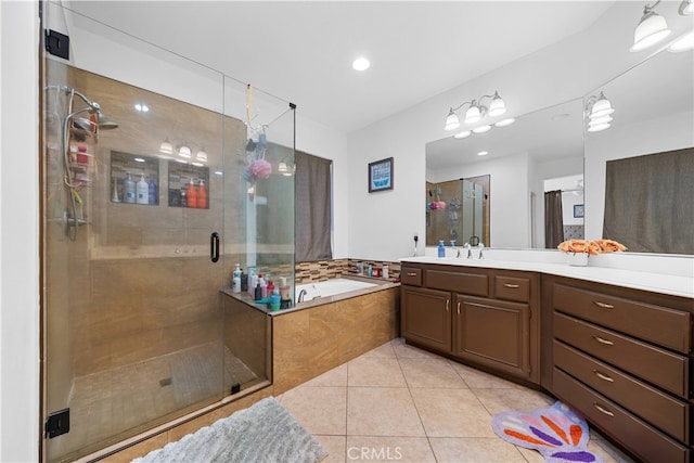 full bathroom featuring a garden tub, tile patterned flooring, vanity, and a shower stall