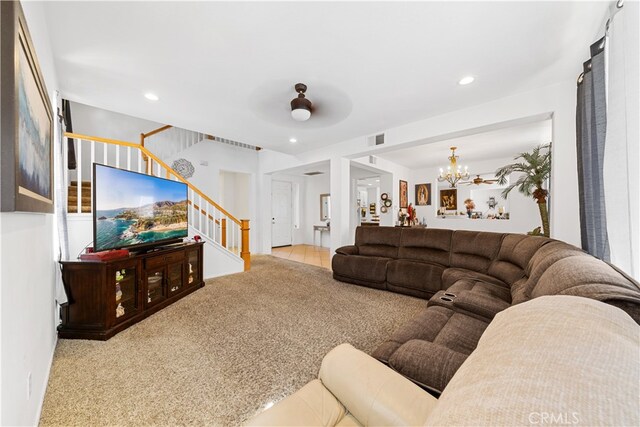 carpeted living room featuring stairs, visible vents, a chandelier, and recessed lighting