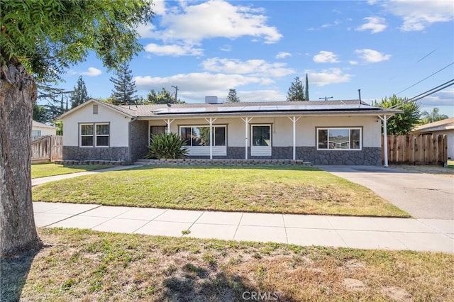 single story home with solar panels, a porch, and a front lawn