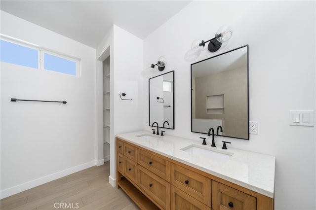 bathroom with hardwood / wood-style flooring and vanity