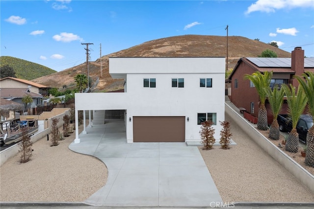 view of front facade featuring a garage and a mountain view