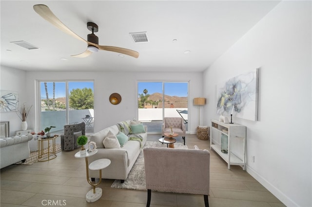 living room with ceiling fan and light hardwood / wood-style floors