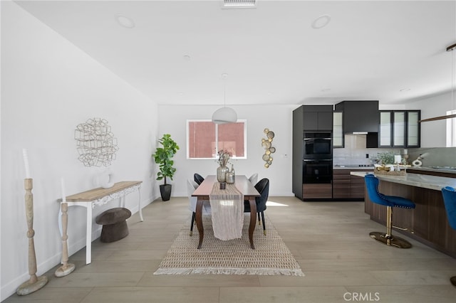 dining space with light hardwood / wood-style flooring