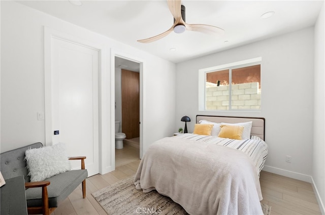 bedroom with ceiling fan, ensuite bathroom, and light hardwood / wood-style floors