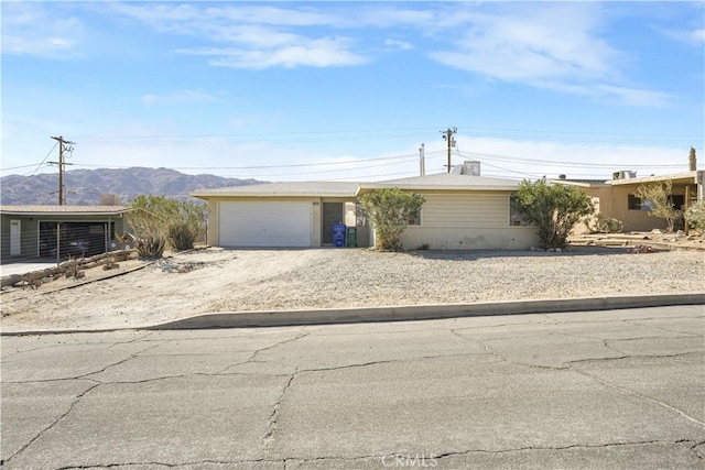 ranch-style house with a mountain view and a garage