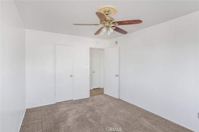 unfurnished bedroom with carpet flooring, a closet, and ceiling fan