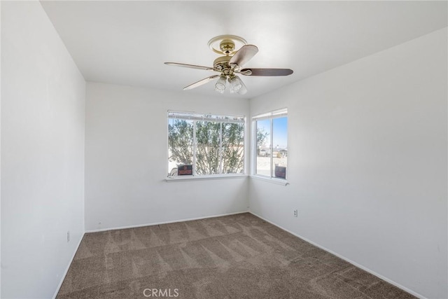 spare room with carpet and ceiling fan