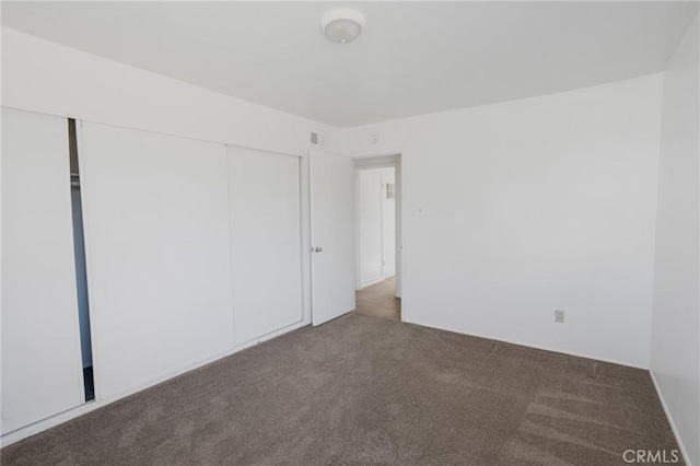 unfurnished bedroom featuring a closet and carpet