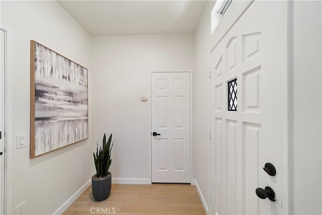 corridor with light wood-type flooring