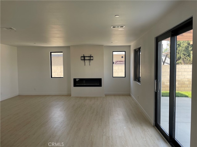 unfurnished living room featuring light wood-type flooring