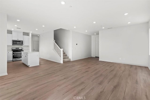 unfurnished living room featuring light hardwood / wood-style flooring