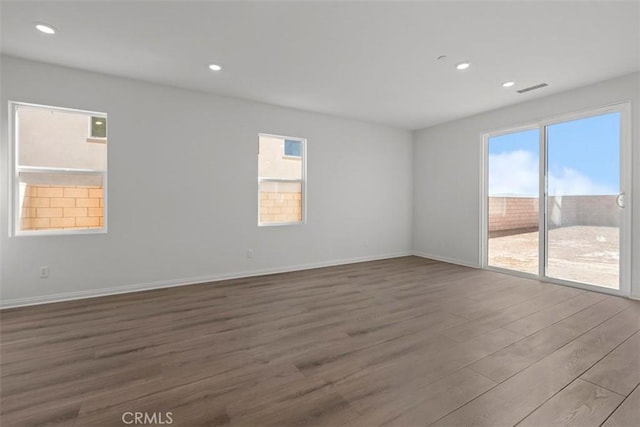 unfurnished room with hardwood / wood-style flooring