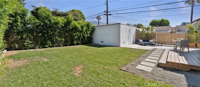 view of yard with a patio area, an outbuilding, and a wooden deck