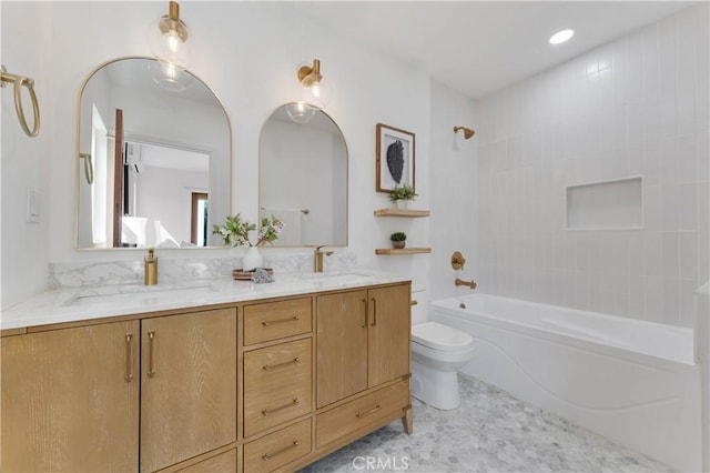 full bathroom with vanity, tile patterned floors, tiled shower / bath combo, and toilet