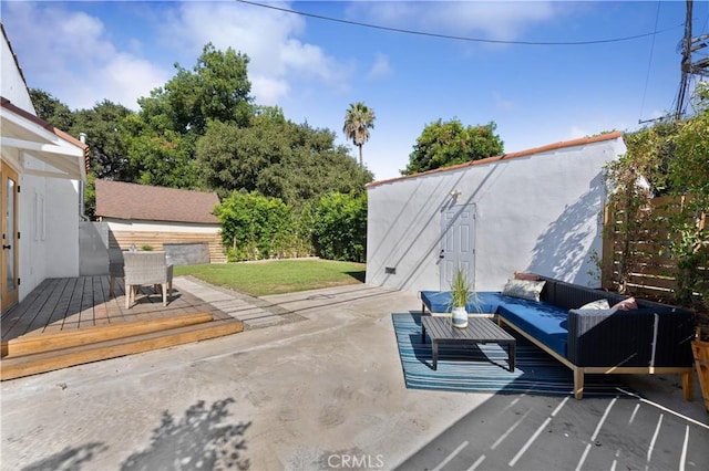 view of patio with outdoor lounge area and a deck