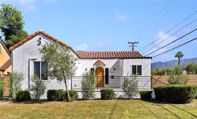 mediterranean / spanish-style home featuring a mountain view and a front yard