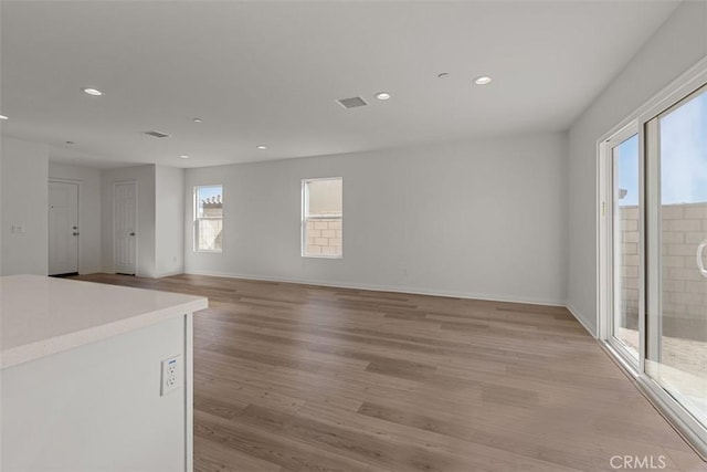 unfurnished room with plenty of natural light and light wood-type flooring