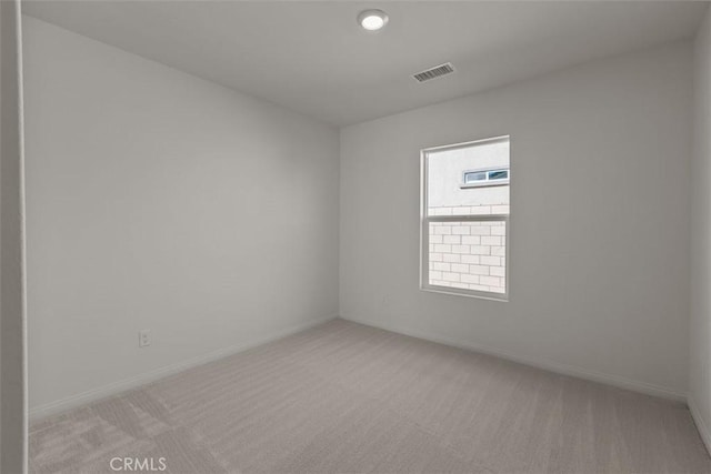 unfurnished room with light colored carpet