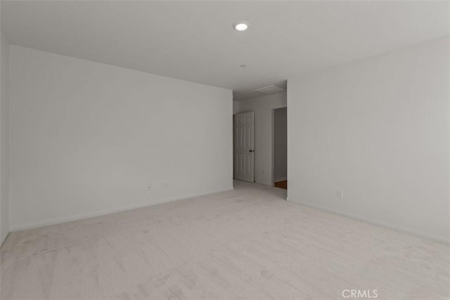 unfurnished room featuring light colored carpet