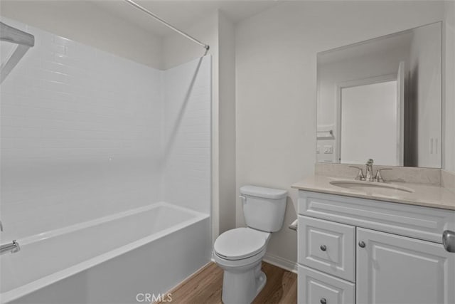 full bathroom with shower / washtub combination, vanity, wood-type flooring, and toilet