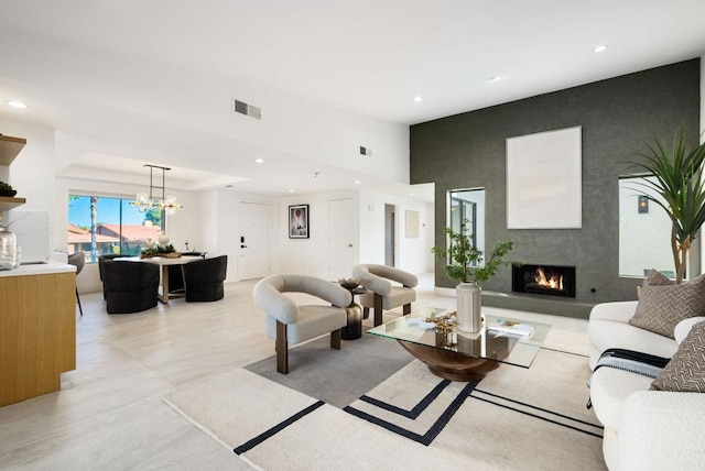 living room with an inviting chandelier and a fireplace