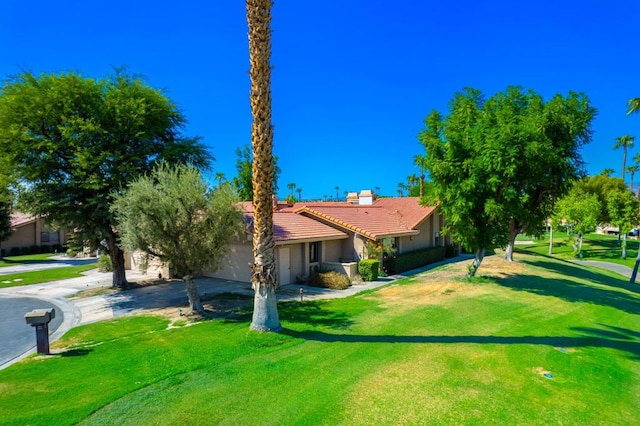 exterior space with a yard and a garage