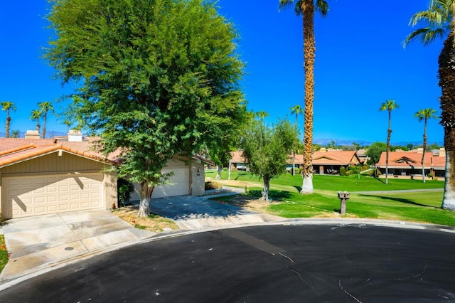 view of front of property featuring a front lawn and a garage