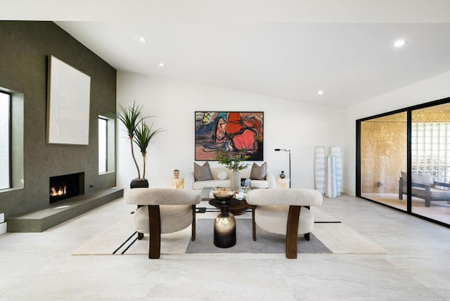 living room with a large fireplace and vaulted ceiling