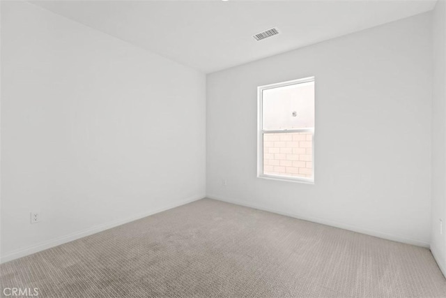 empty room with carpet and visible vents