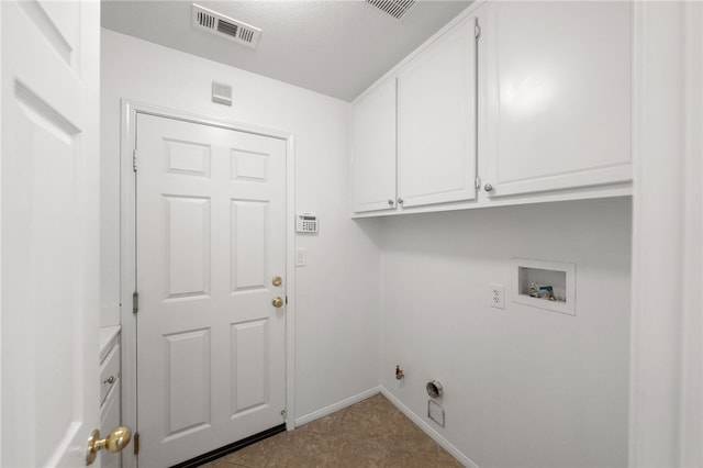 clothes washing area featuring cabinets, hookup for a washing machine, a textured ceiling, and gas dryer hookup