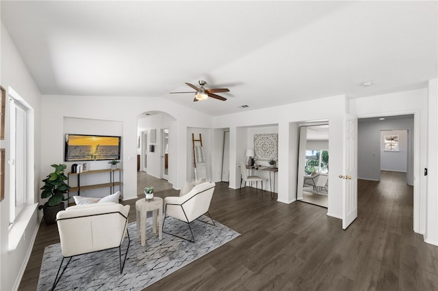 living room featuring dark hardwood / wood-style floors, ceiling fan, and lofted ceiling