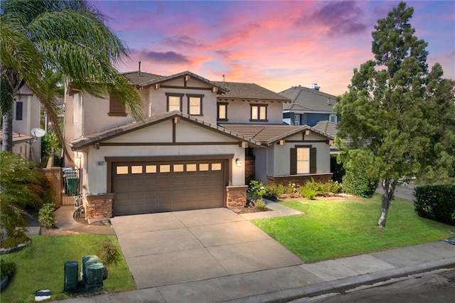 view of front of property featuring a garage and a yard