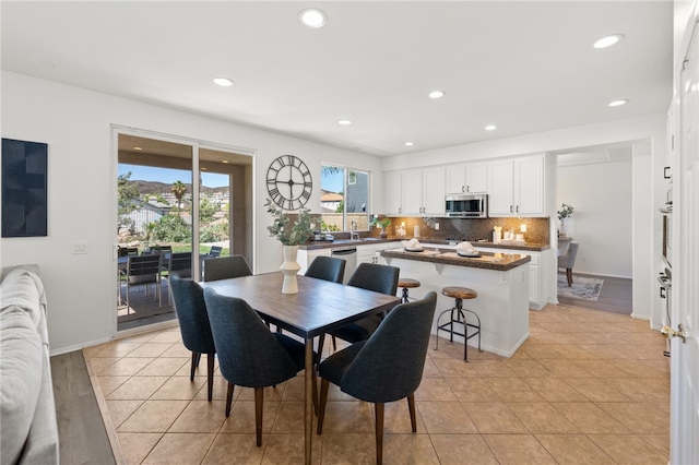 dining area featuring light wood-type flooring and sink