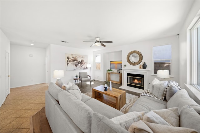 living room with tile patterned floors and ceiling fan