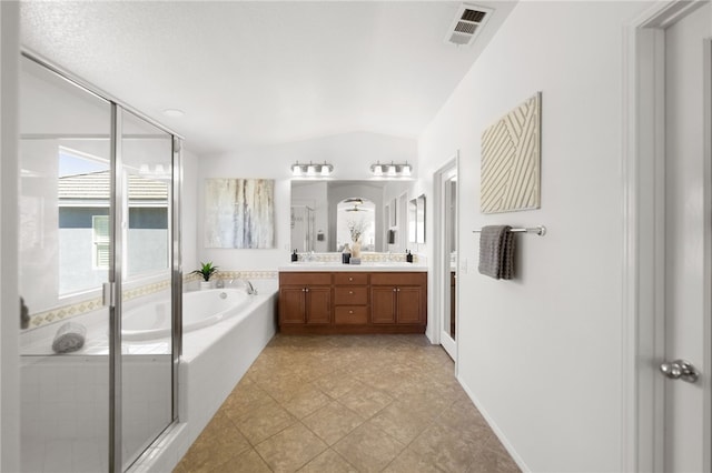 bathroom featuring tile patterned floors, vanity, plus walk in shower, and vaulted ceiling