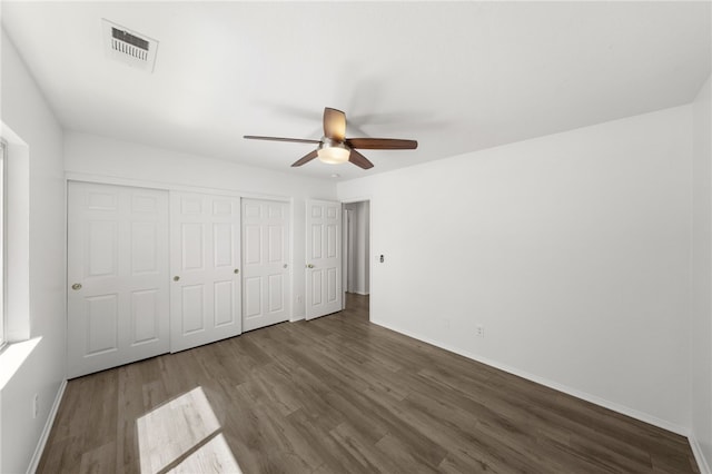 unfurnished bedroom featuring ceiling fan and dark hardwood / wood-style floors