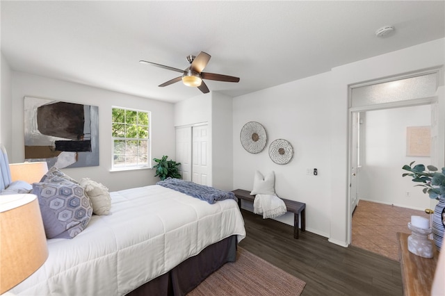 bedroom with a closet, ceiling fan, and dark wood-type flooring