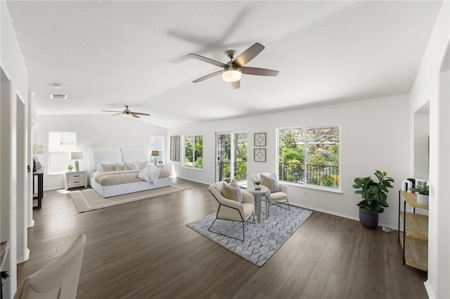 living room with ceiling fan, dark wood-type flooring, and vaulted ceiling