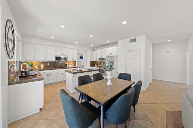 dining room with light tile patterned floors and sink